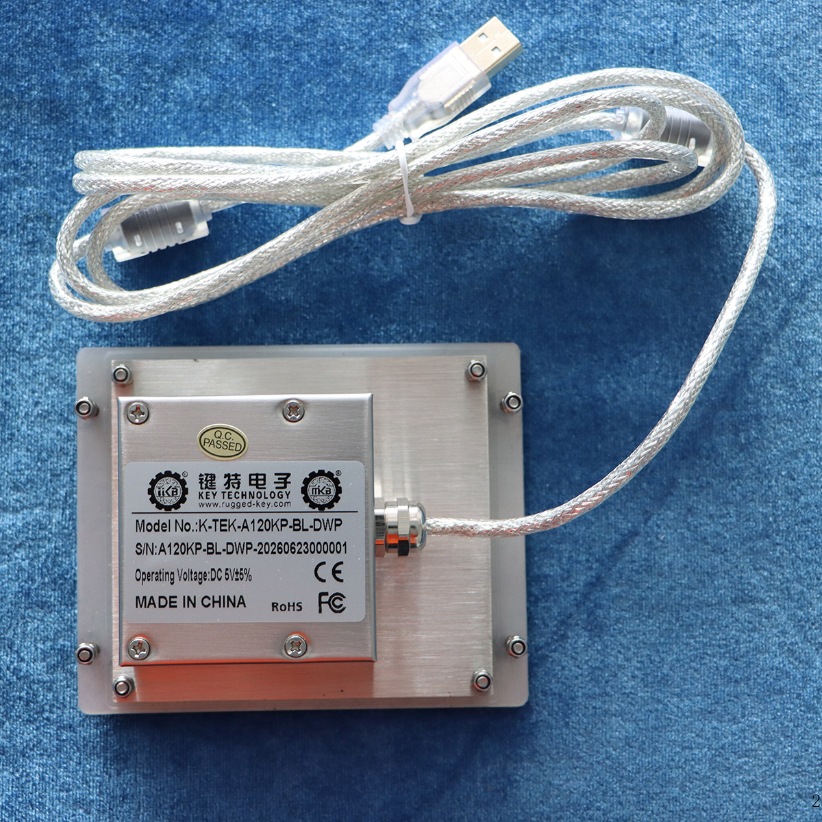 Rear view of the Newdesy K-TEK-A120KP stainless steel keypad showing panel-mount studs, protected electronics enclosure and USB cable