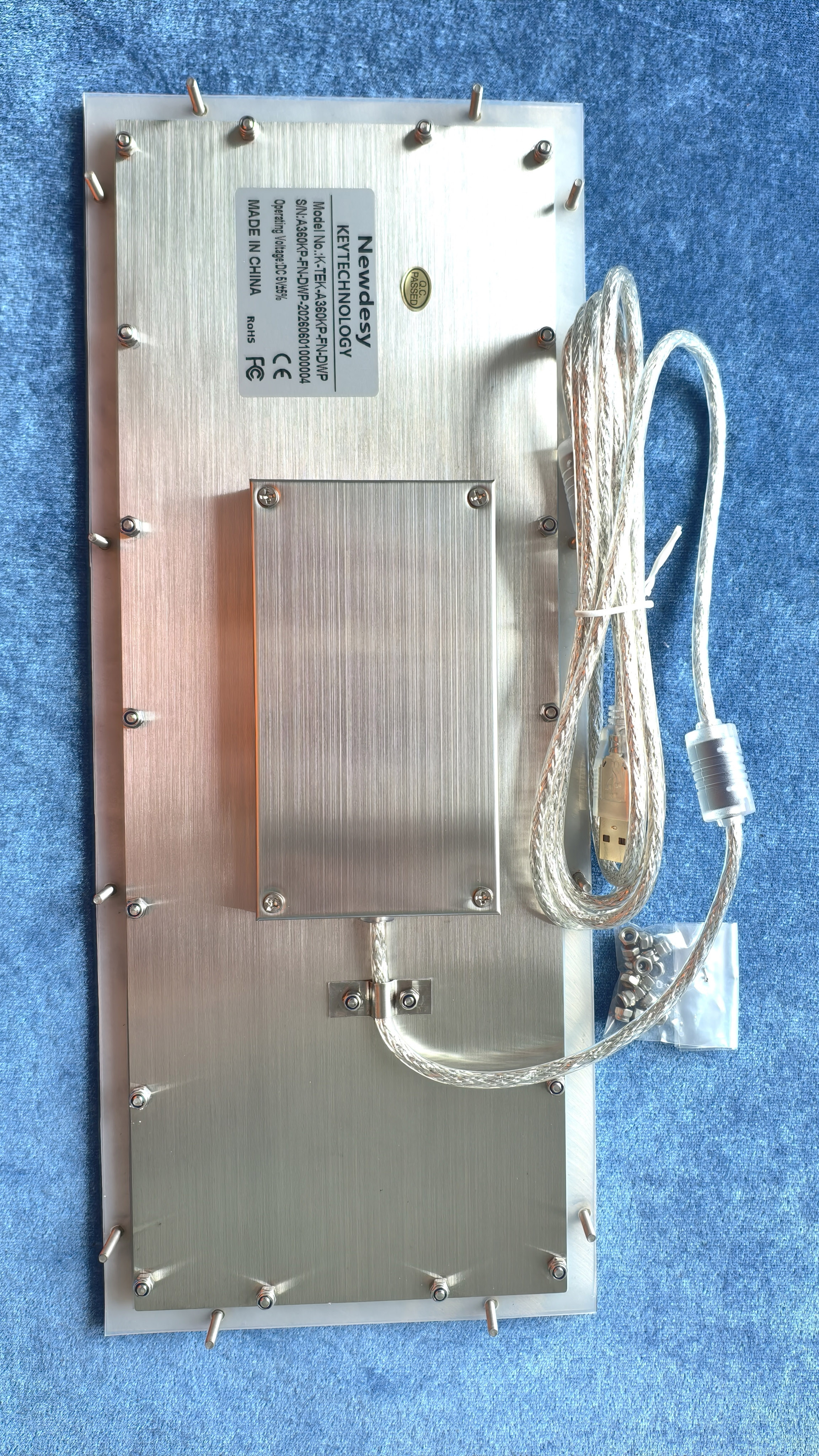 Rear view of the Newdesy K-TEK-A360KP-FN-DWP showing threaded mounting studs, protected electronics enclosure and USB cable